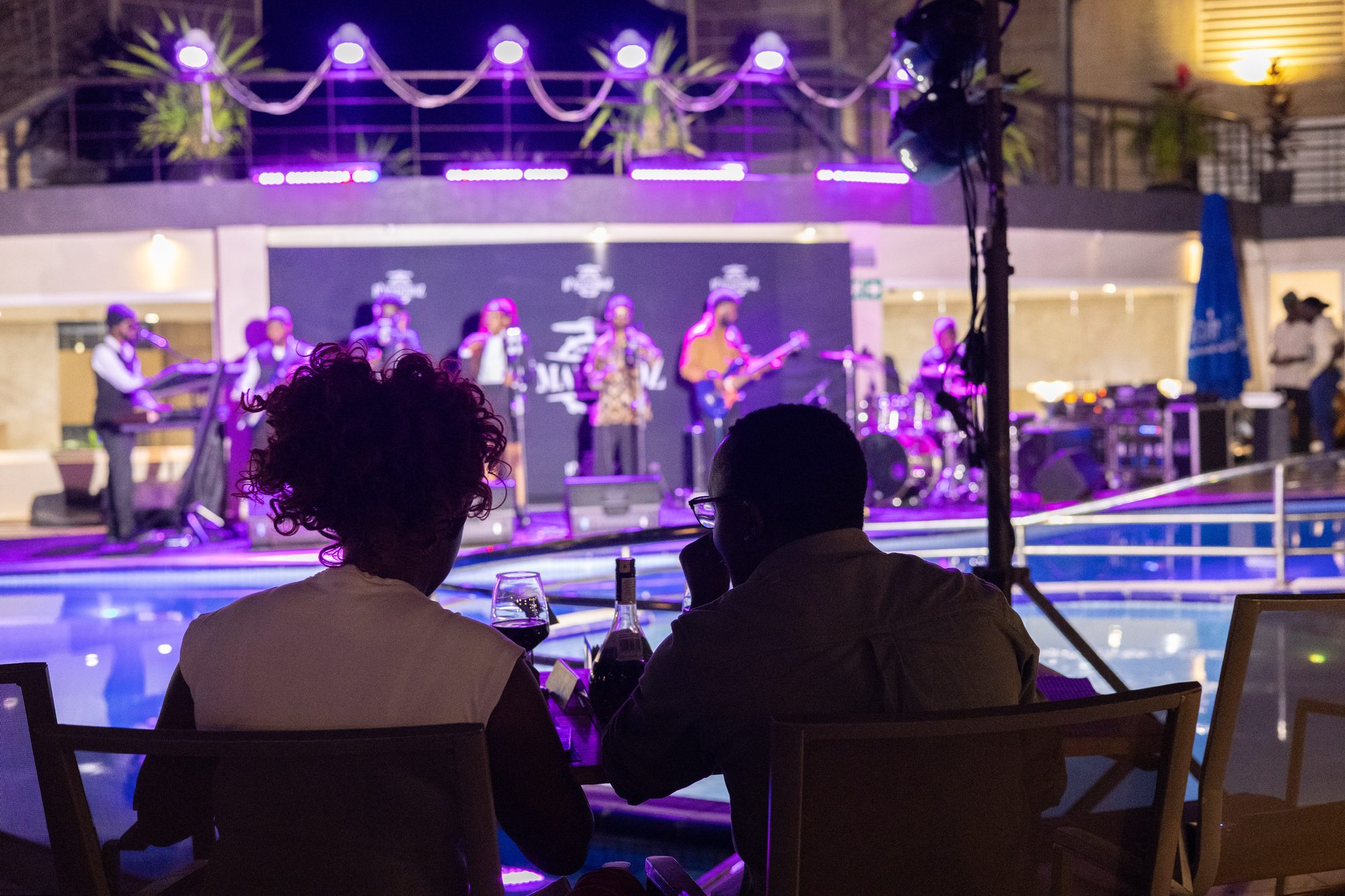 A live band performing poolside at Skyz Hotel Kampala