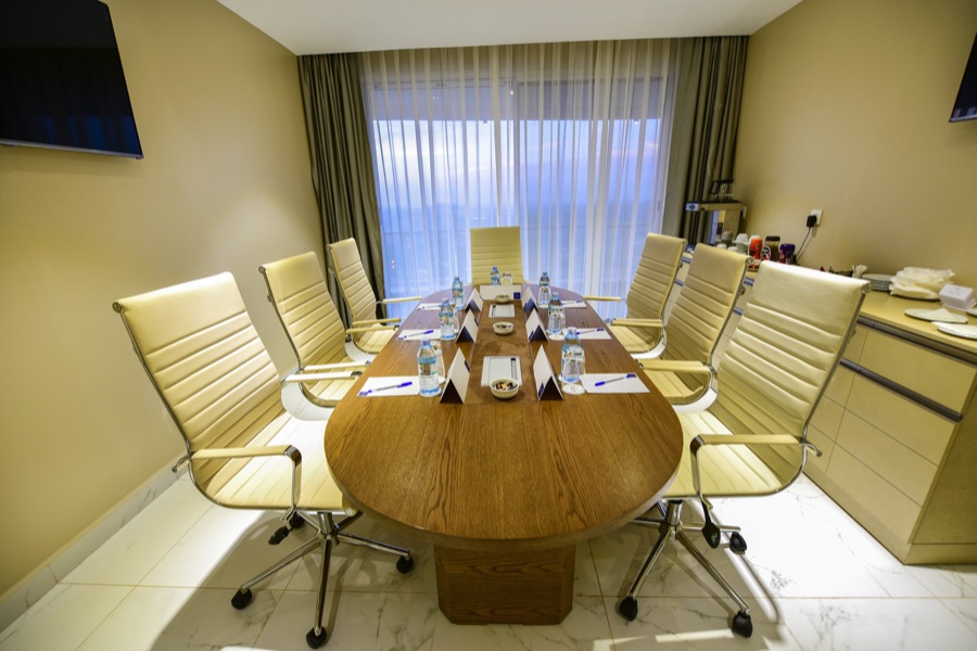 One of Skyz Hotel Kampala's boardrooms set for a meeting with city views through the window