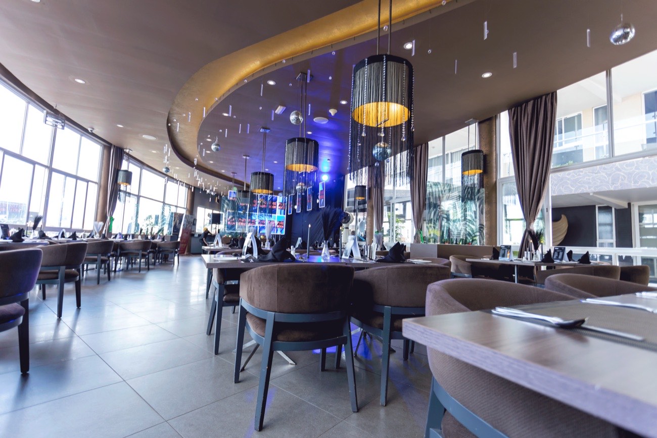 Chapter Two Restaurant dressed for a private evening event, with beaded pendant lamps, hanging disco spheres and tables set with black linen