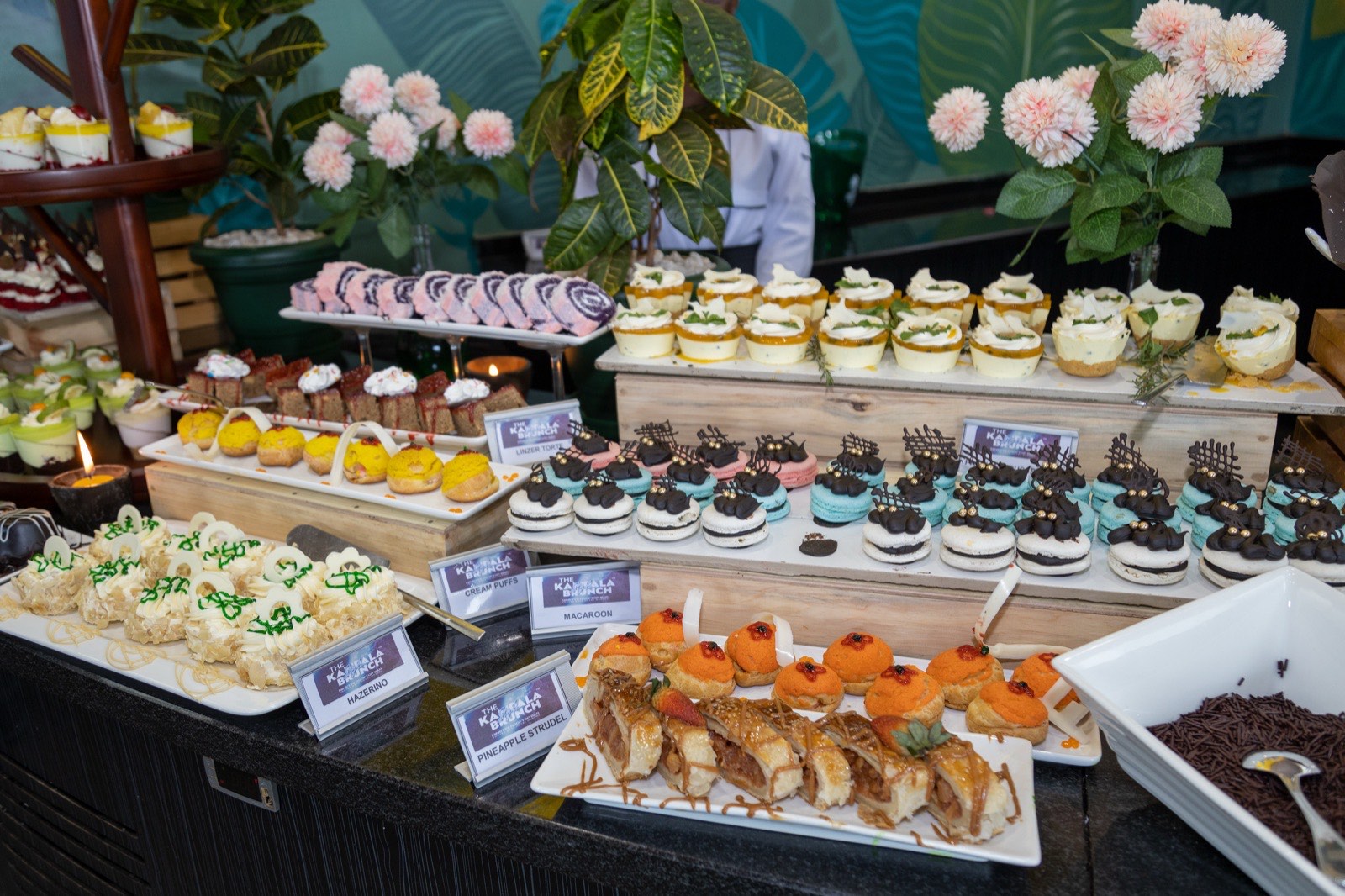 A branded dessert table with macarons, cream puffs and pineapple strudel at The Kampala Style Brunch, September 2024