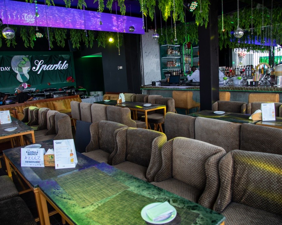 Ninety9 Rooftop's indoor lounge with reserved tables set for an evening event