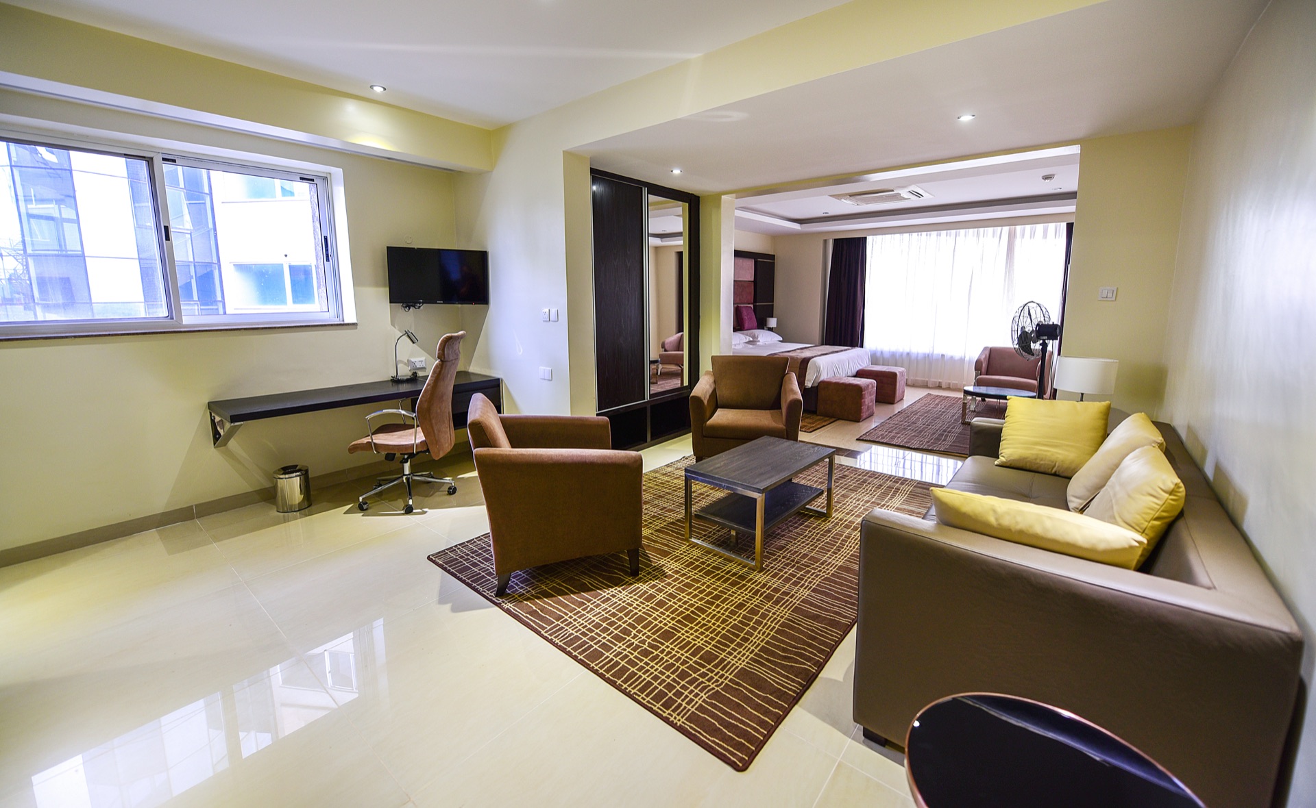 Presidential Suite living and bedroom area with city-view windows