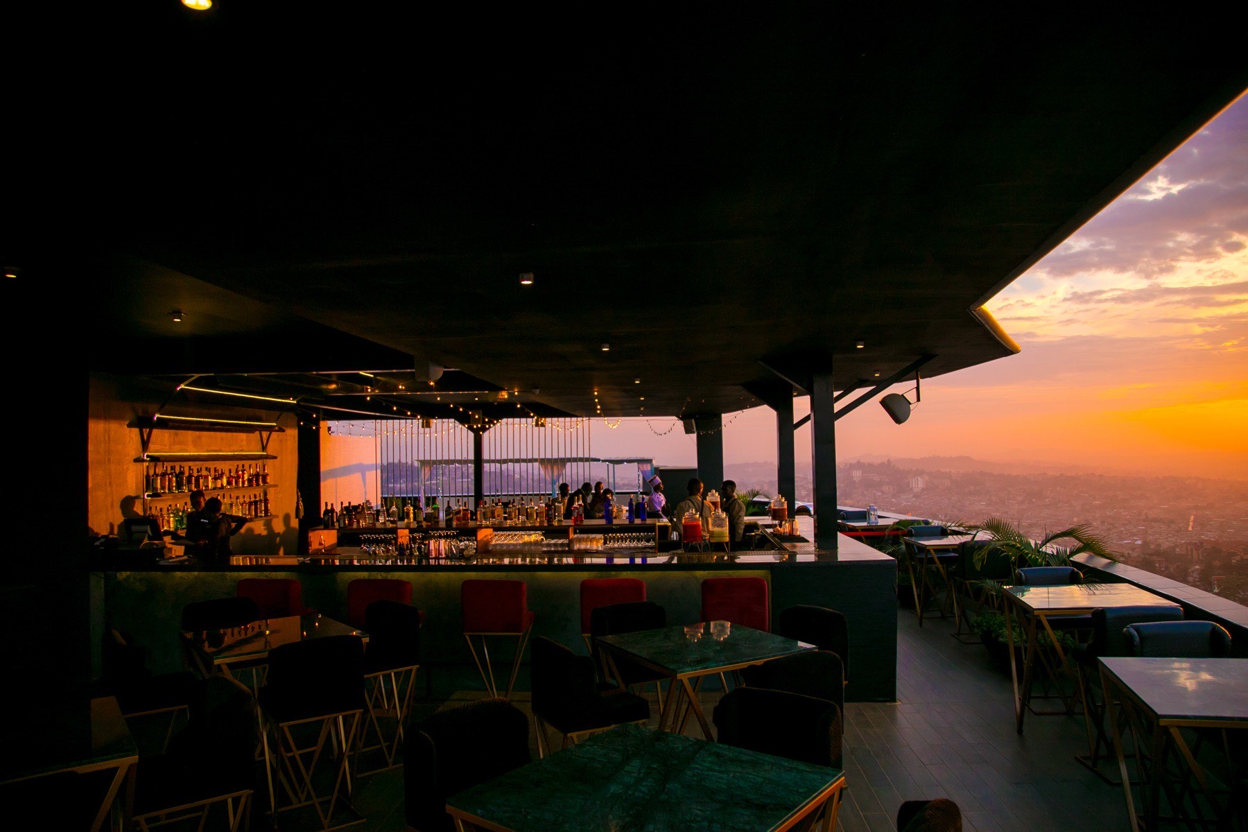 The rooftop bar glowing at sunset over Kampala