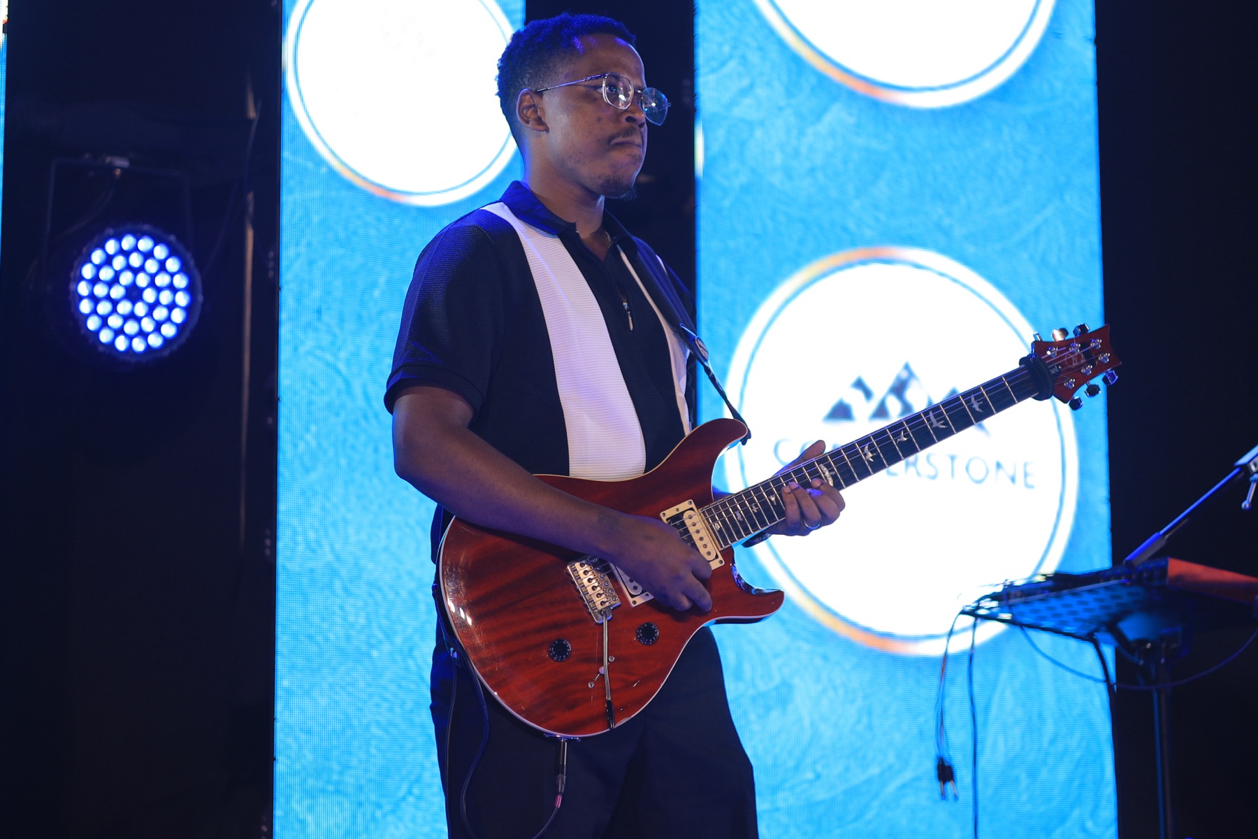 A guitarist performing live on stage at the Soul RNB Experience