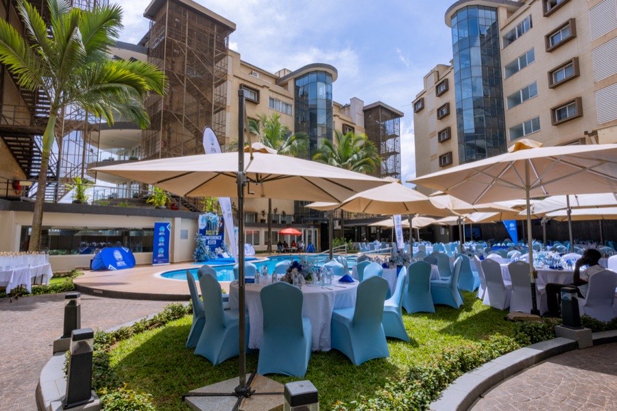 A corporate conference set up under umbrellas beside the Tropicanna pool