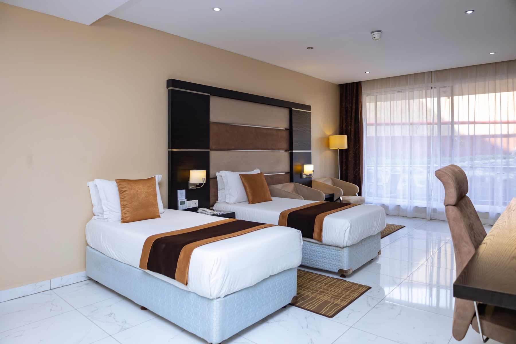One Bedroom Twin Suite with two twin beds and a separate sitting area